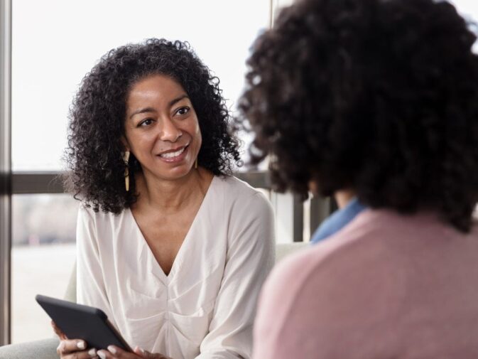 smiling therapist talking to patient